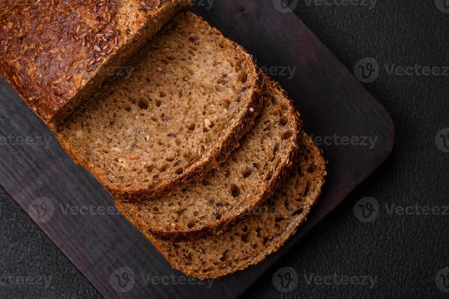 Delicious fresh crispy brown bread with grains and seeds photo