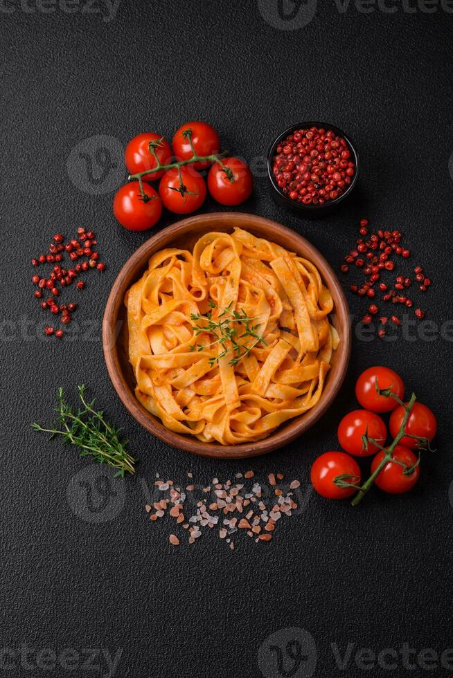 Delicious fresh pasta with pesto sauce, salt, spices and herbs on a ceramic plate photo