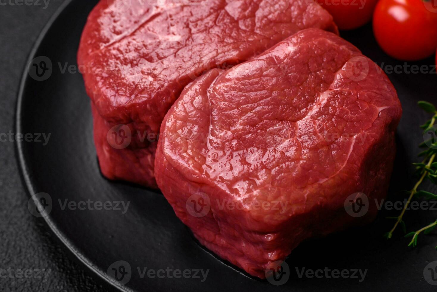 Raw fillet steak mignon beef with salt, spices and herbs photo