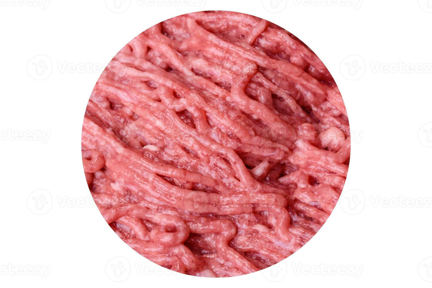 Fresh minced beef on cutting board on dark background with ingredients for cooking photo