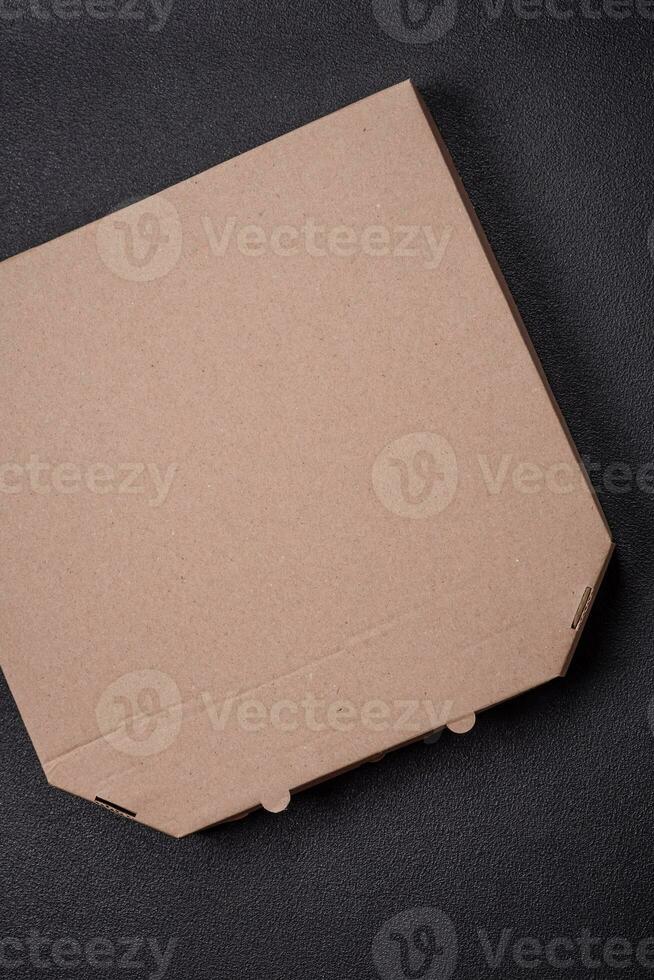 Empty cardboard rectangular brown box for delivery of delicious pizza photo