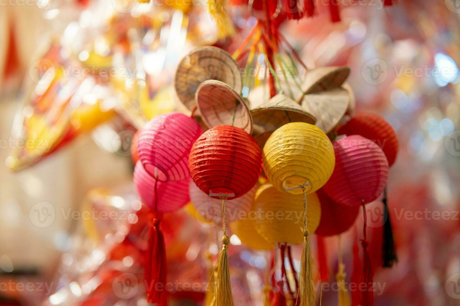 Decorated colorful lanterns hanging on a stand in the streets in Ho Chi Minh City, Vietnam during Mid Autumn Festival. Chinese language in photos mean money and happiness