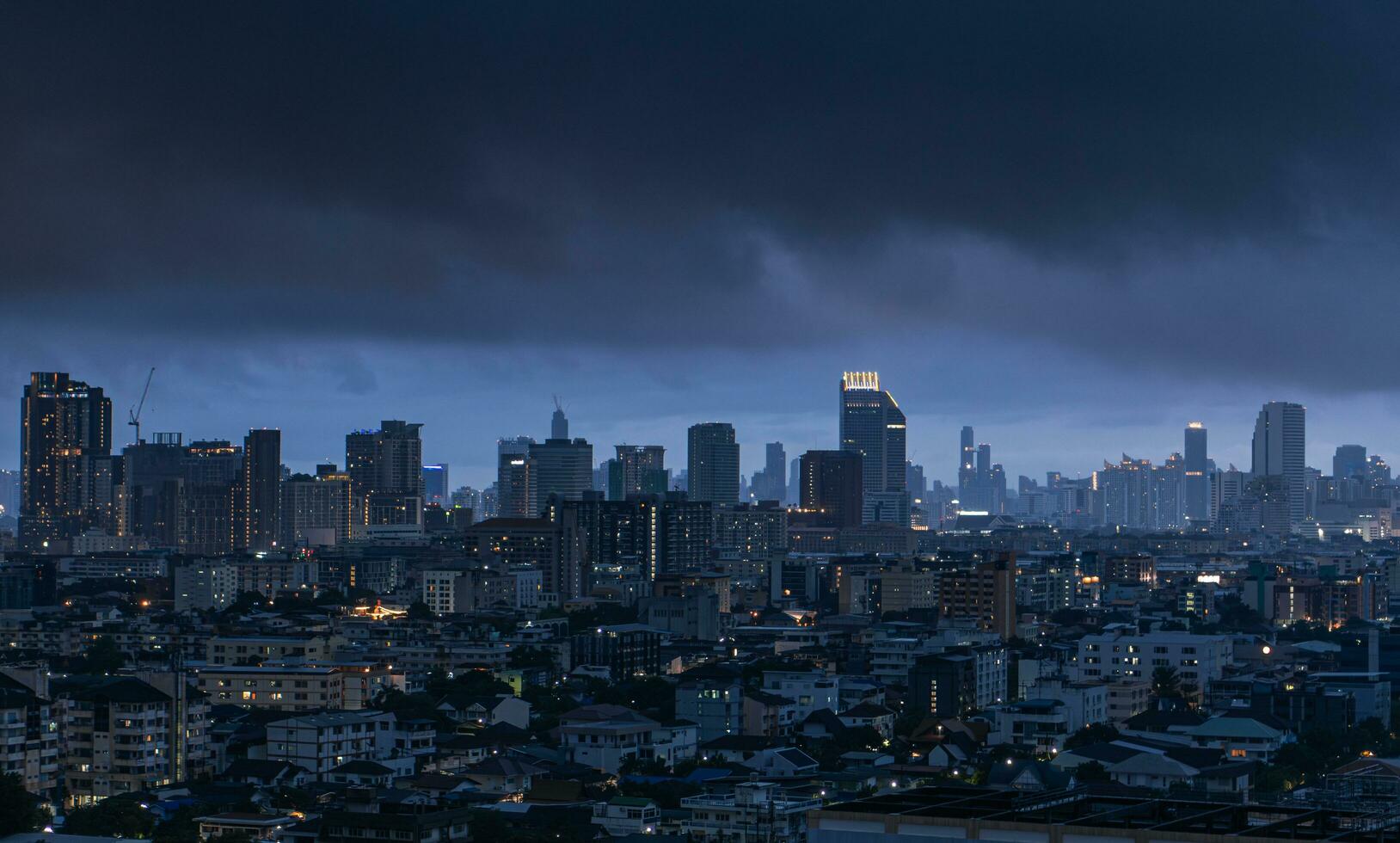 View city of Bangkok in Thailand before the storm in the twilight , rainy season thick clouds cover the town, global warming climate change concept photo