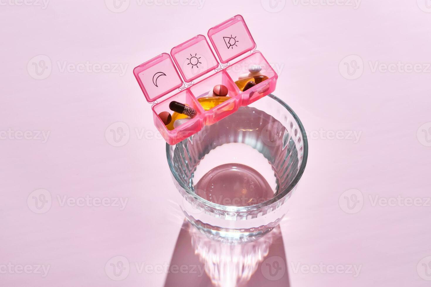 Bright pill box with different pills and vitamins. photo