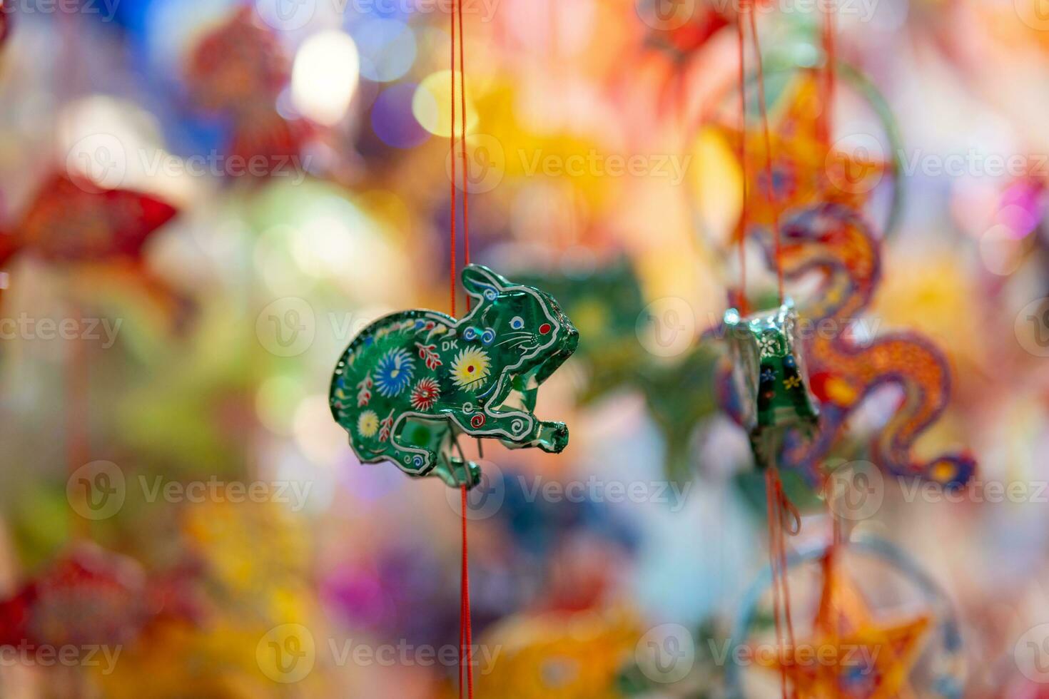 Decorated colorful lanterns hanging on a stand in the streets in Ho Chi Minh City, Vietnam during Mid Autumn Festival. Chinese language in photos mean money and happiness. Selective focus.