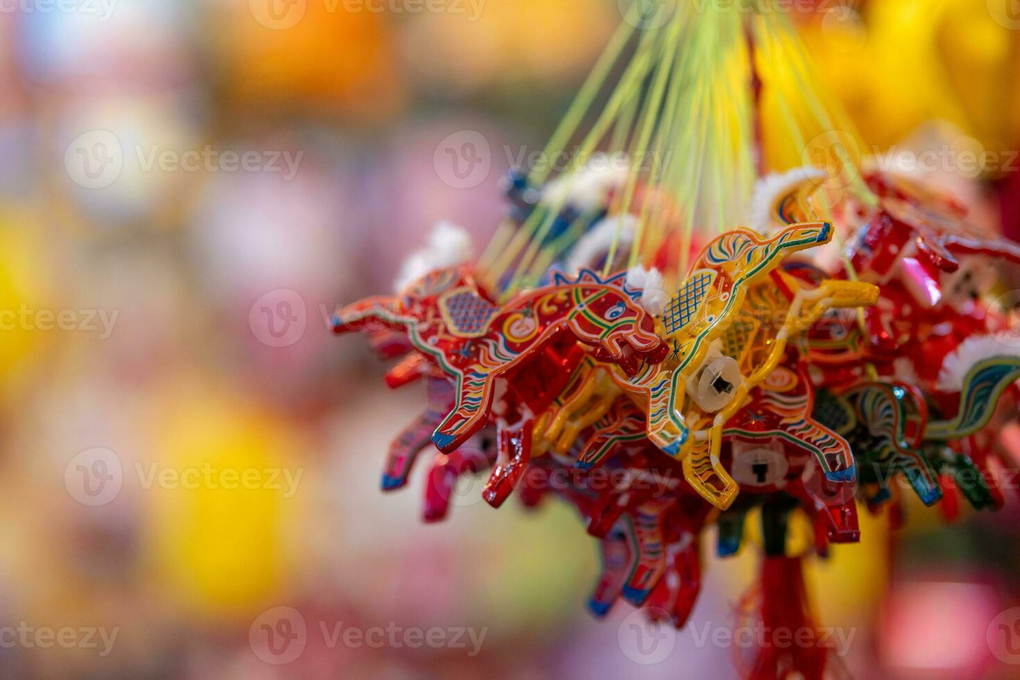 Decorated colorful lanterns hanging on a stand in the streets in Ho Chi Minh City, Vietnam during Mid Autumn Festival. Chinese language in photos mean money and happiness. Selective focus.