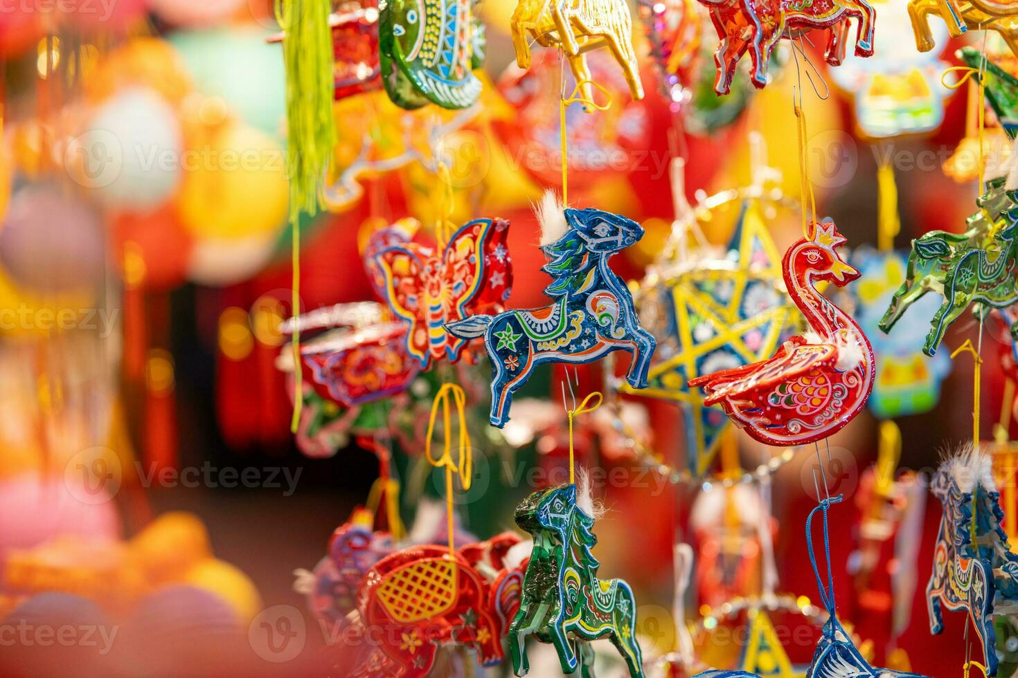 Decorated colorful lanterns hanging on a stand in the streets in Ho Chi Minh City, Vietnam during Mid Autumn Festival. Chinese language in photos mean money and happiness