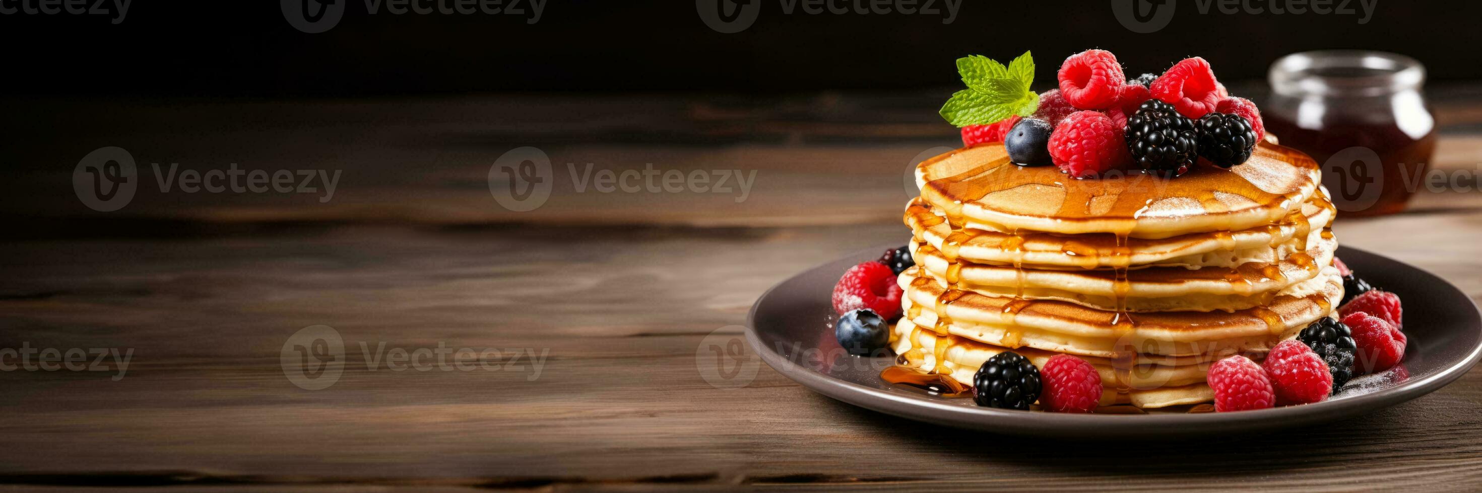 Pancakes stacked with berries syrup isolated on a white background photo
