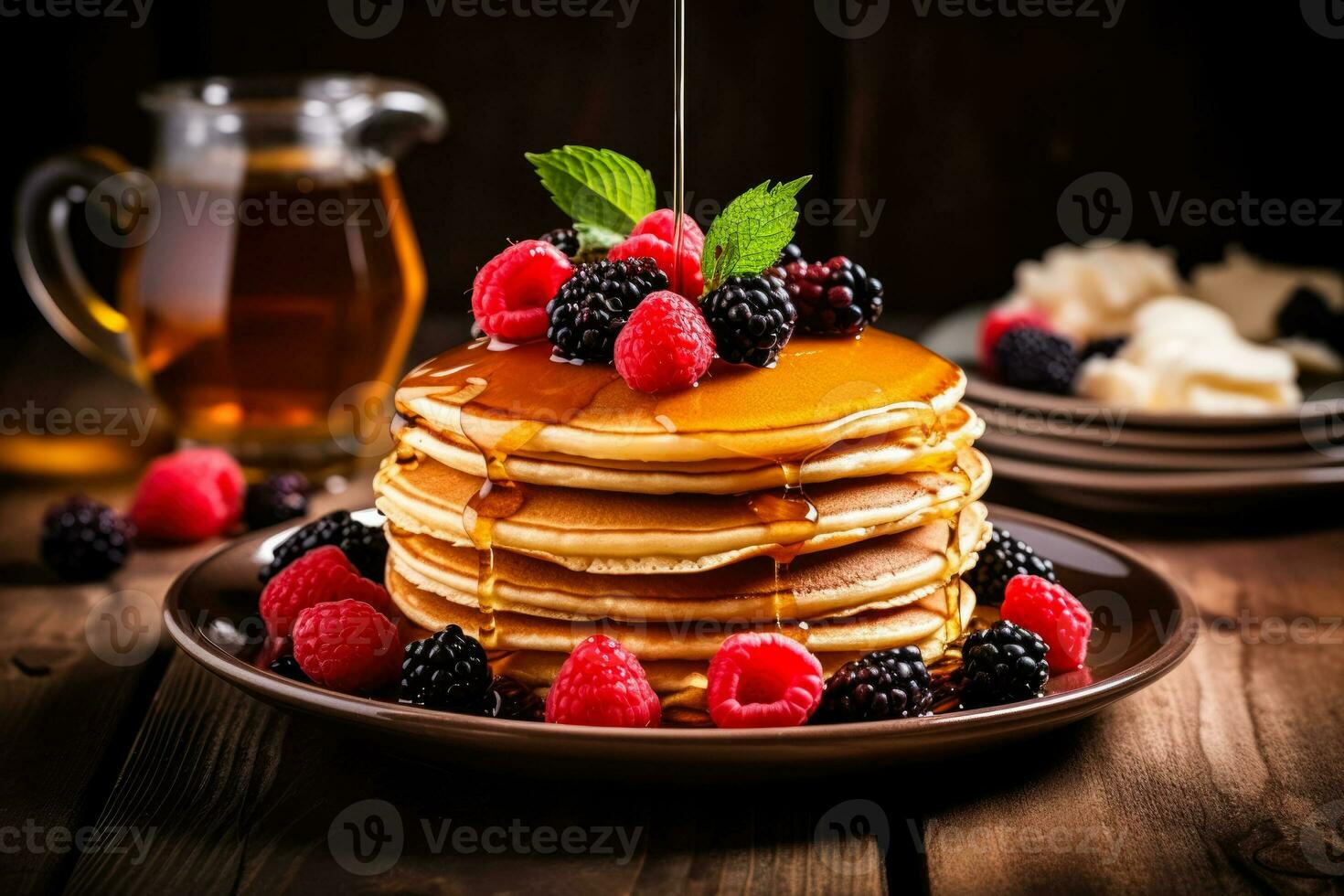 Inviting stack of pancakes adorned with syrup and berries on rustic table photo