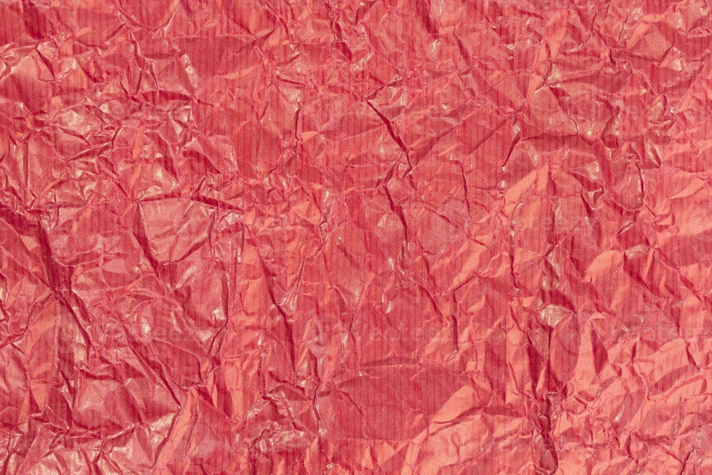Red crumpled paper texture background. Full frame photo