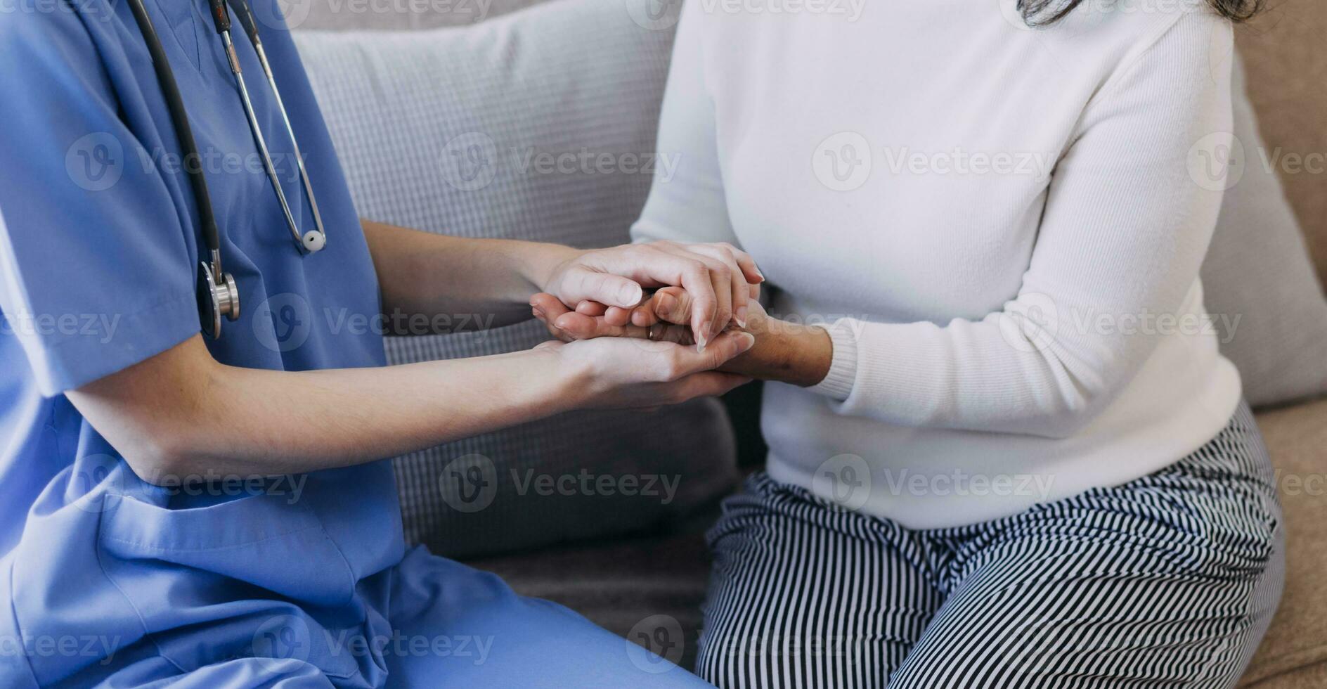 Homecare nursing service and elderly people cardiology healthcare. Close up of young hispanic female doctor nurse check mature caucasian man patient heartbeat using stethoscope during visit photo