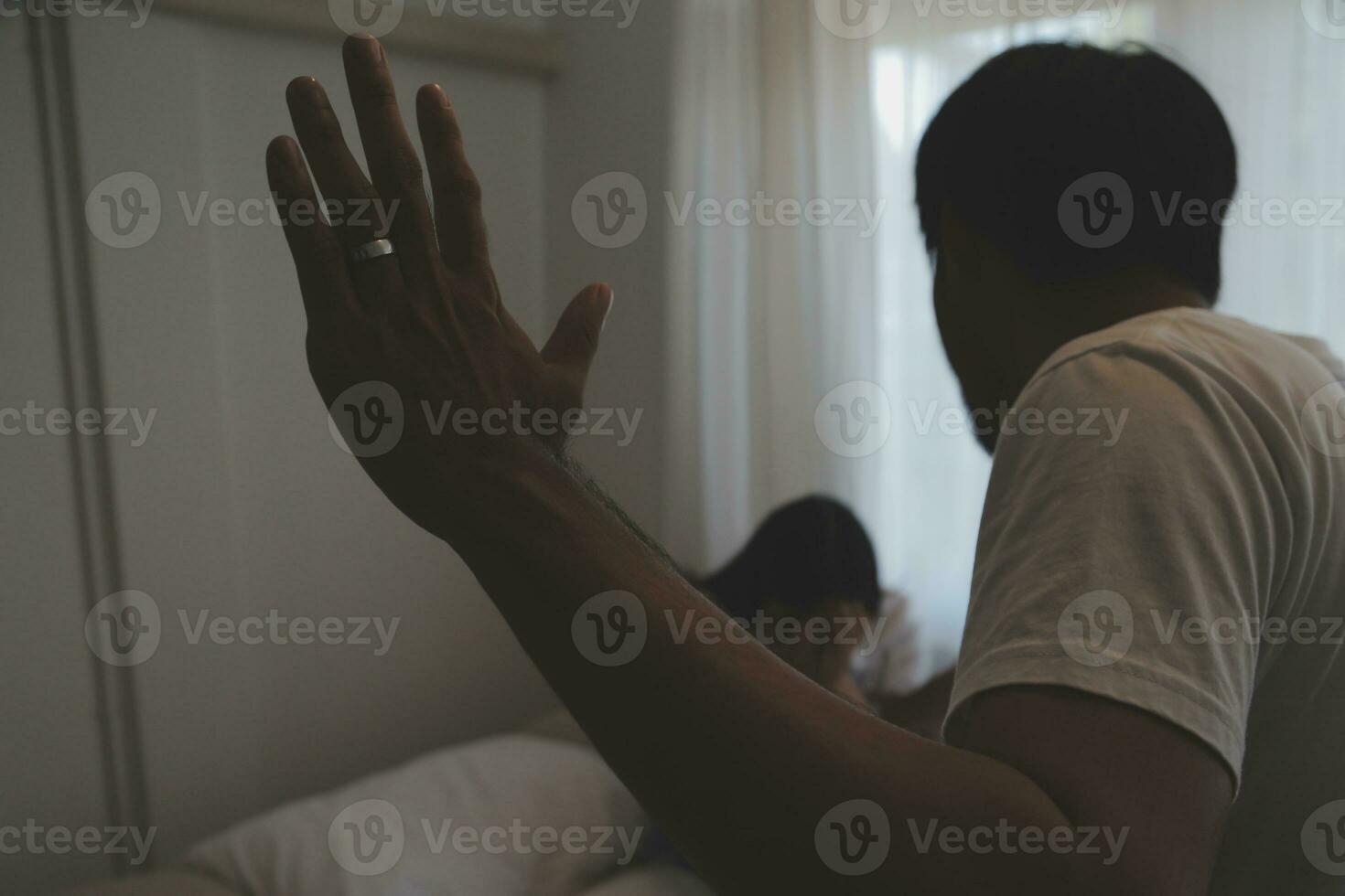 Upset woman having a fight with a man at home. Hispanic wife slapping the face of her husband during an argument because of their relationship problems photo