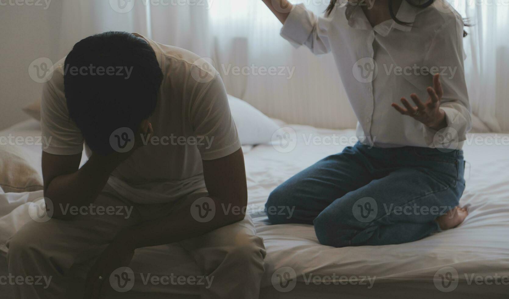 Upset woman having a fight with a man at home. Hispanic wife slapping the face of her husband during an argument because of their relationship problems photo