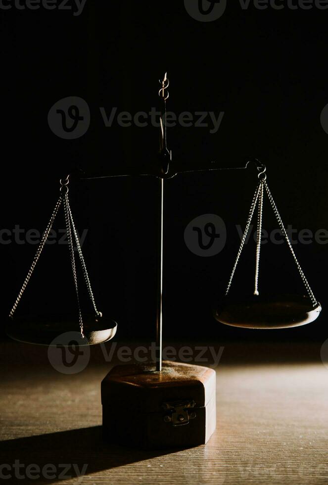 Business and lawyers discussing contract papers with brass scale on desk in office. Law, legal services, advice, justice and law concept picture with film grain effect photo