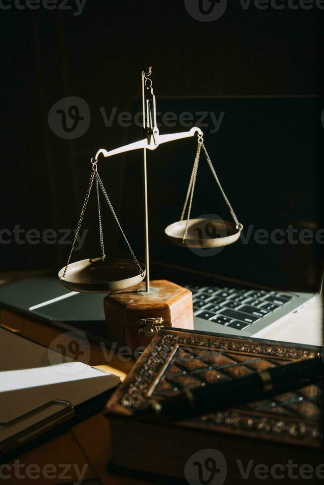 law legal technology concept. judge gavel on computer with scales of justice on desk of lawyer. photo