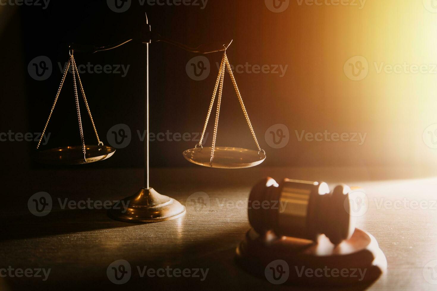 Business and lawyers discussing contract papers with brass scale on desk in office. Law, legal services, advice, justice and law concept picture with film grain effect photo