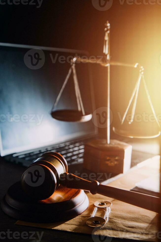 law legal technology concept. judge gavel on computer with scales of justice on desk of lawyer. photo