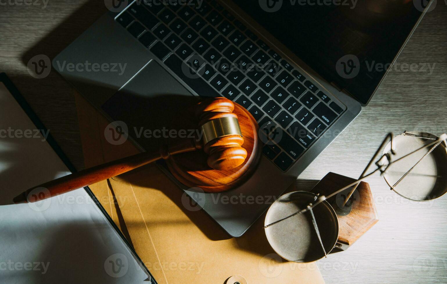 law legal technology concept. judge gavel on computer with scales of justice on desk of lawyer. photo