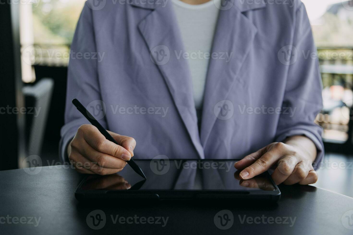 Asian Business woman using calculator and laptop for doing math finance on an office desk, tax, report, accounting, statistics, and analytical research concept photo