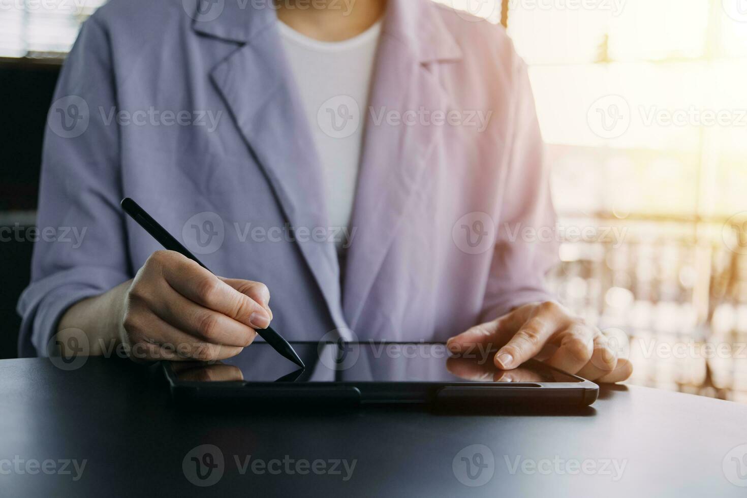 Asian Business woman using calculator and laptop for doing math finance on an office desk, tax, report, accounting, statistics, and analytical research concept photo