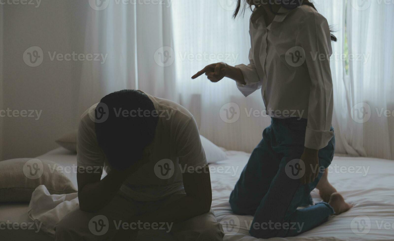 Upset woman having a fight with a man at home. Hispanic wife slapping the face of her husband during an argument because of their relationship problems photo