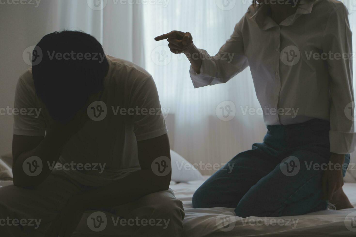 Upset woman having a fight with a man at home. Hispanic wife slapping the face of her husband during an argument because of their relationship problems photo