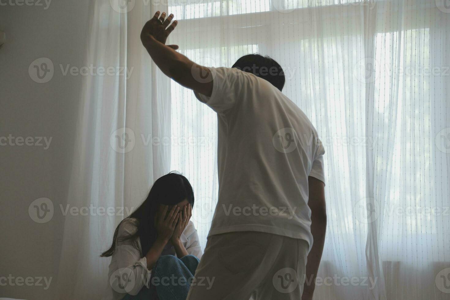 Upset woman having a fight with a man at home. Hispanic wife slapping the face of her husband during an argument because of their relationship problems photo