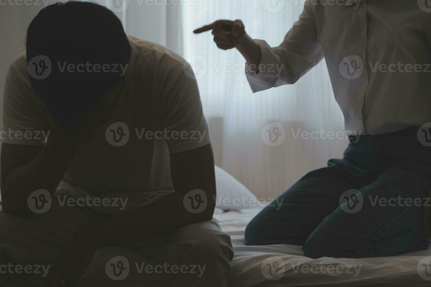 Upset woman having a fight with a man at home. Hispanic wife slapping the face of her husband during an argument because of their relationship problems photo