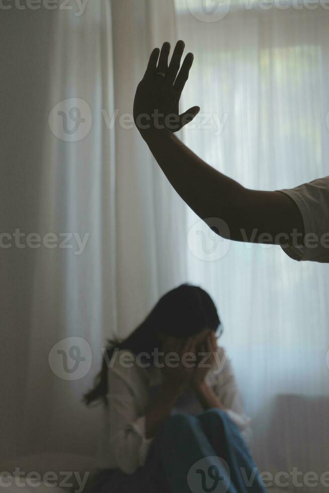 Upset woman having a fight with a man at home. Hispanic wife slapping the face of her husband during an argument because of their relationship problems photo