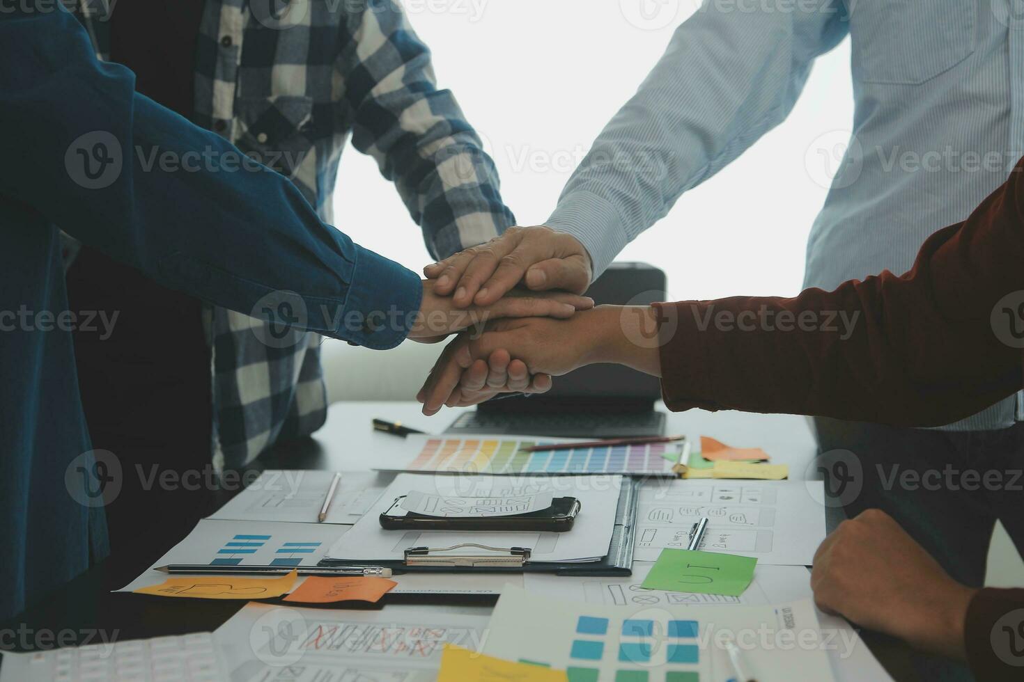 Close up ux developer and ui designer brainstorming about mobile app interface wireframe design on table with customer breif and color code at modern office.Creative digital development agency photo