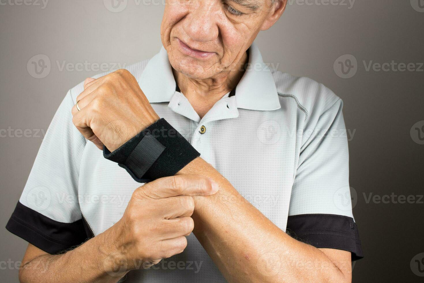 Man wearing a wrist brace or wrap on his left hand and wrist for pain management photo