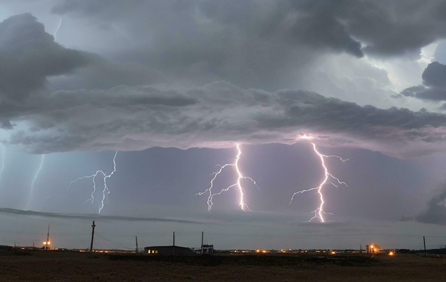 Thick black clouds flashed lightning in the sky photo