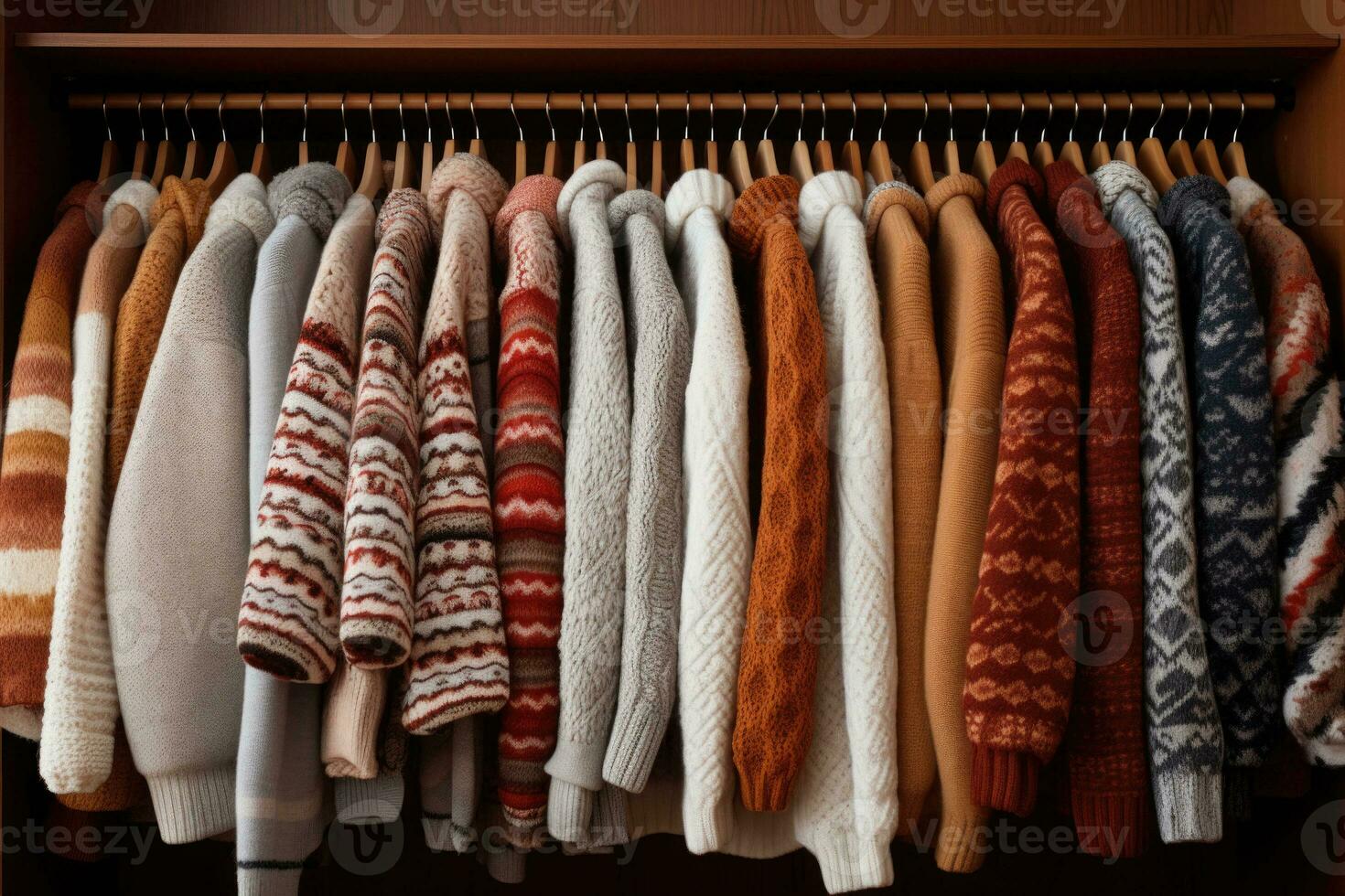 Row of ornate warm knitted sweaters hang on hangers. Generative AI photo