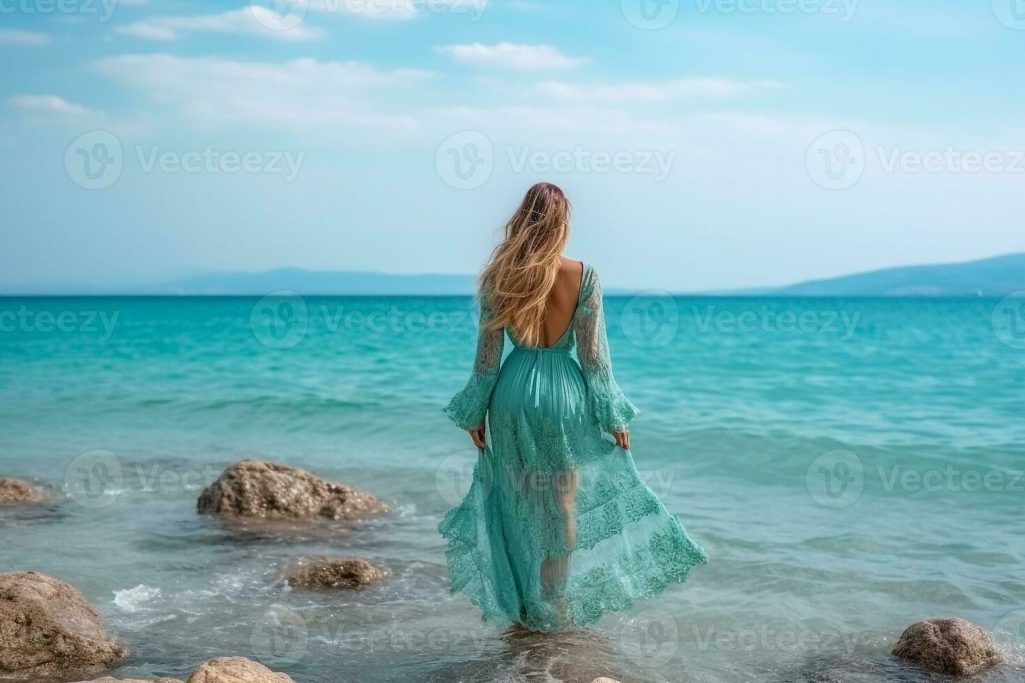 Beautiful woman in dress standing on rock with beautiful sea background.Generative Ai. photo