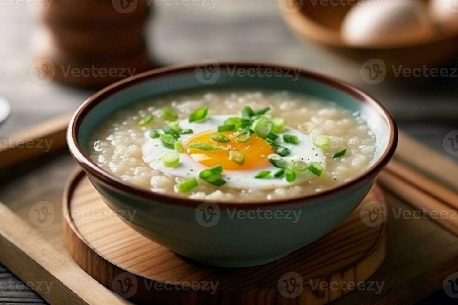 Porridge rice gruel with boiled eggs in bowl on table photo