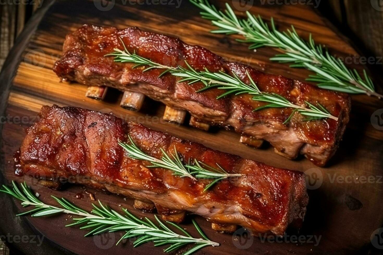 Fresh grilled pork with rosemary on a wooden background photo