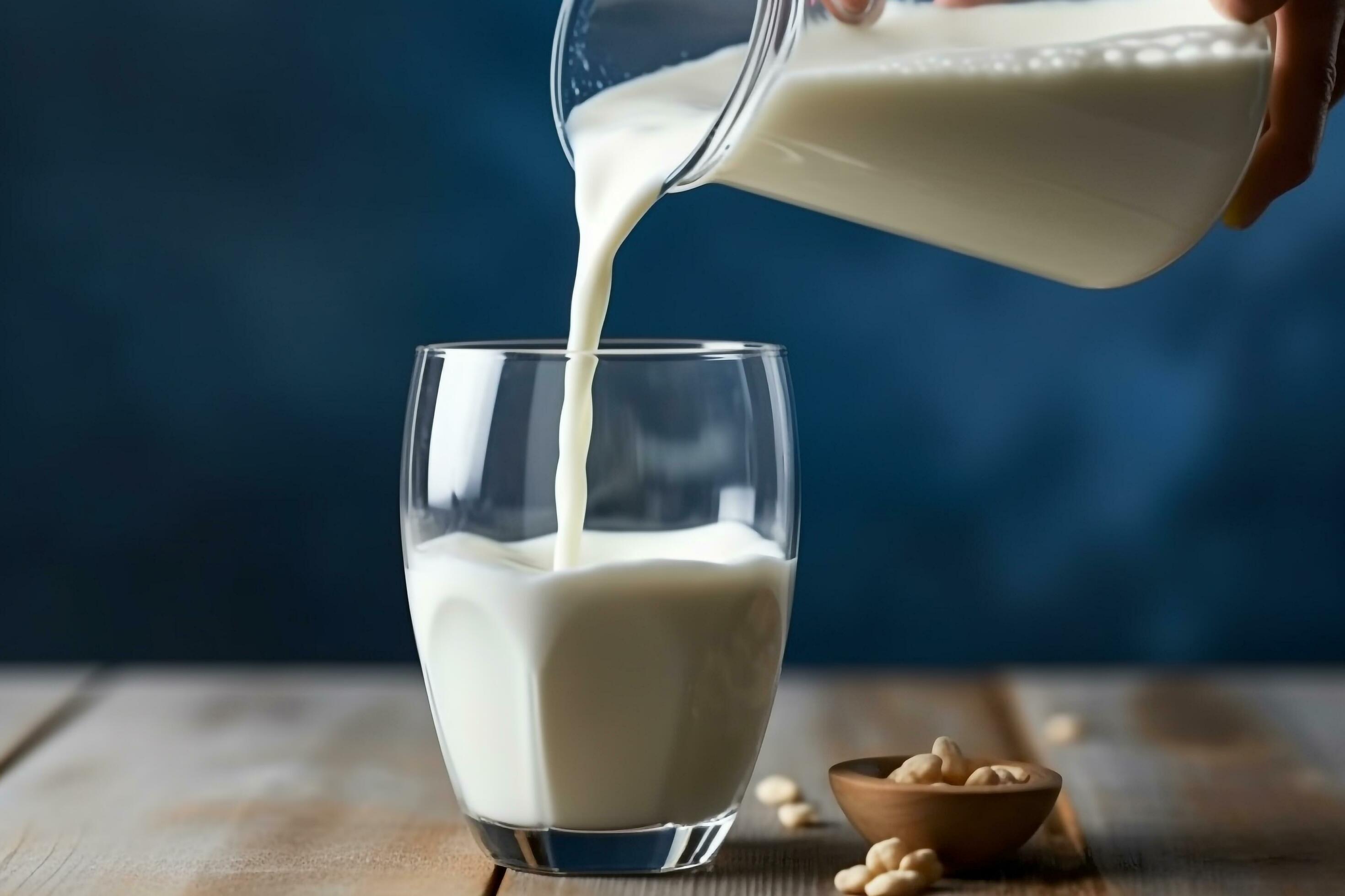 Pouring milk on blue background 29558498 Stock Photo at Vecteezy