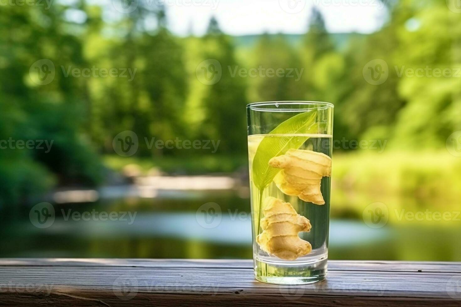 Ginger water in glass with ginger on wooden table background photo