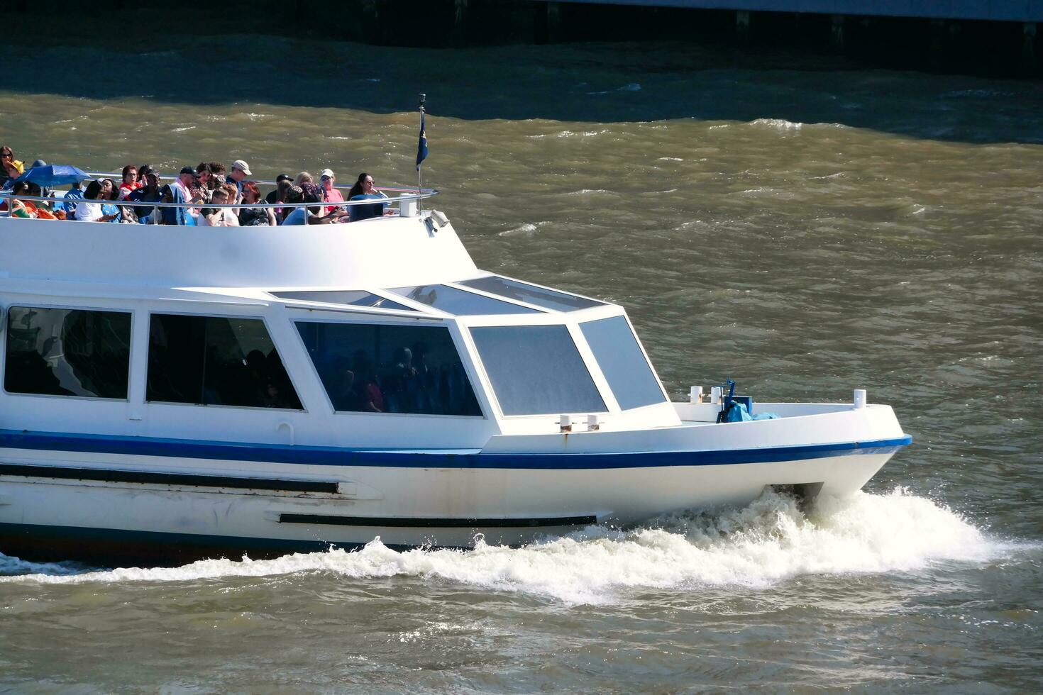 Best View of Boat over River Thames Waters at London Bridge, Capital City of England Great Britain. The Image Was Captured June 4th, 2023 photo