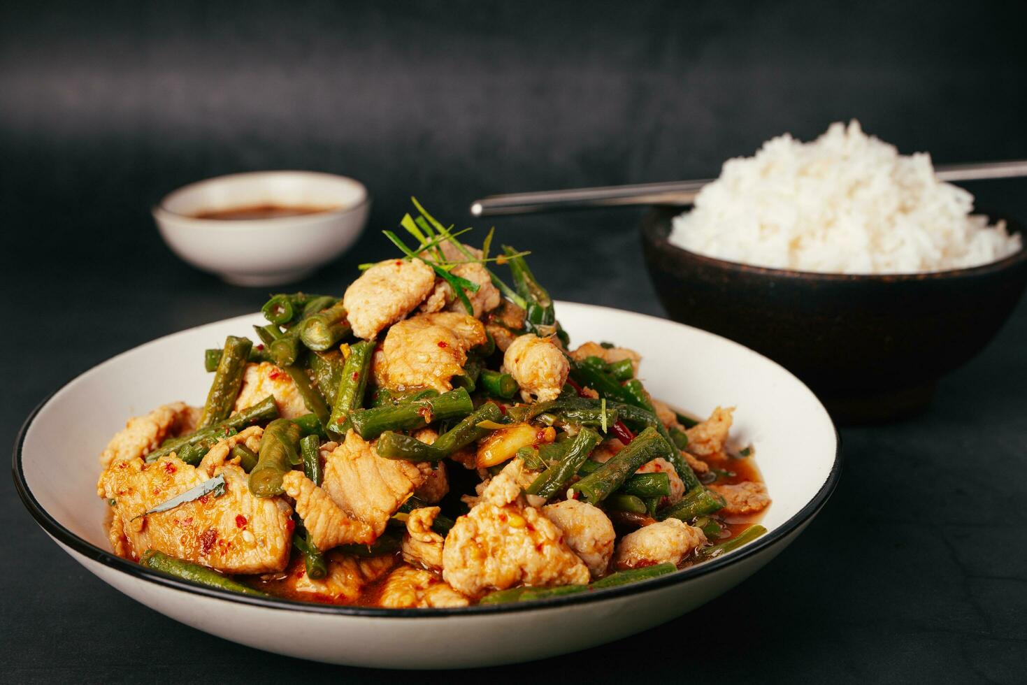 Close up, Tasty Stir-fried pork and red hot curry paste with or long bean and Ingredients are oyster sauce, fish sauce, sugar, kaffir lime leaves in the dish Eat with cooked rice. Thai food photo