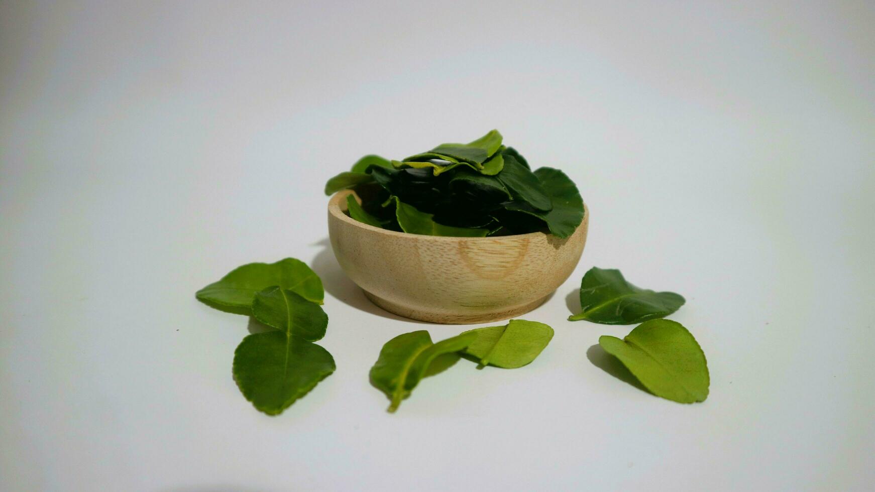 Daun Jeruk Purut. Kaffir lime leaves used for aromatic Indonesian cuisine, including soup, curry, rice, stir fry, chips, and salads. photo