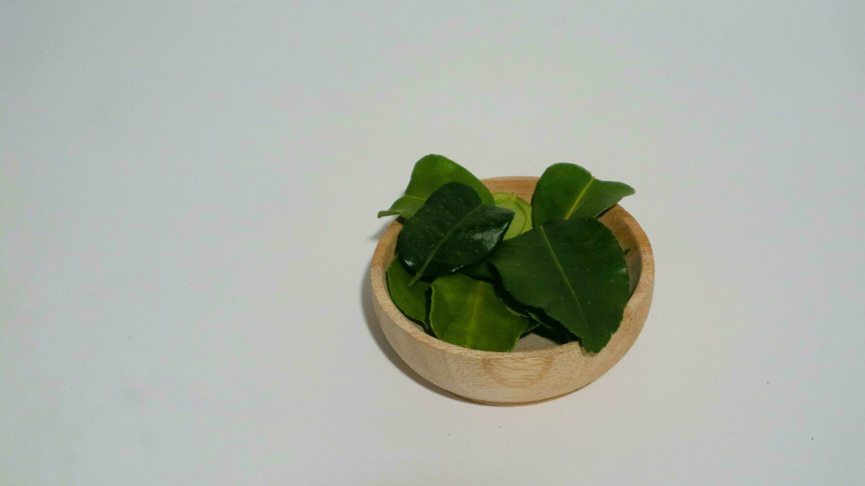 Daun Jeruk Purut. Kaffir lime leaves used for aromatic Indonesian cuisine, including soup, curry, rice, stir fry, chips, and salads. photo