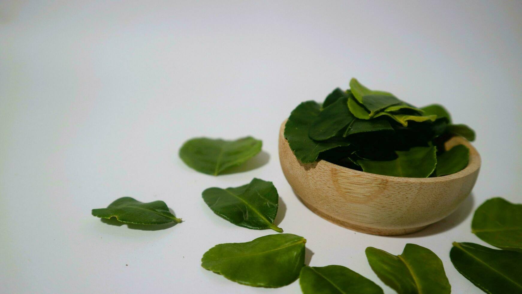 Daun Jeruk Purut. Kaffir lime leaves used for aromatic Indonesian cuisine, including soup, curry, rice, stir fry, chips, and salads. photo
