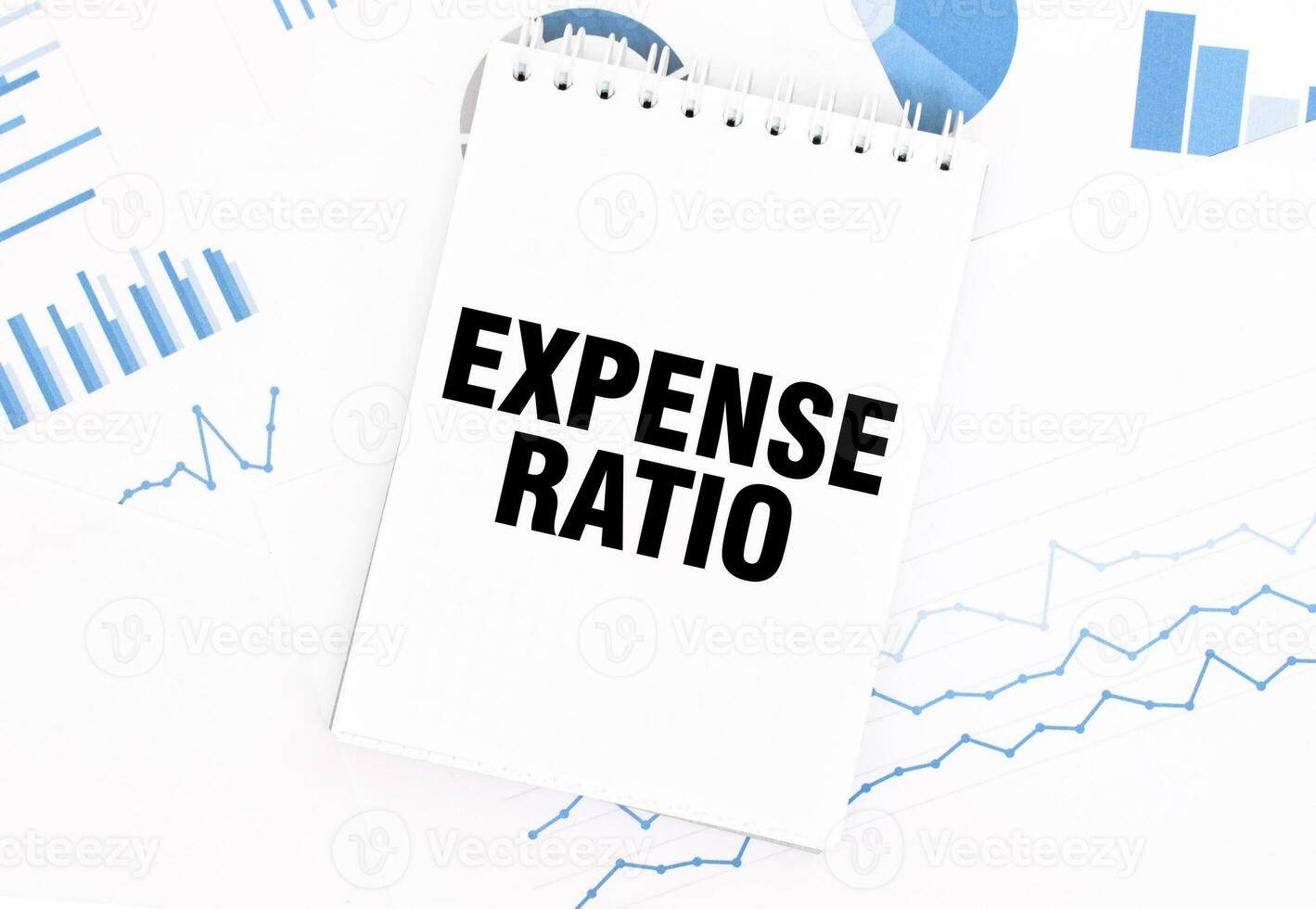 White notepad with text EXPENSE RATIO on the financial documentation. Finance and business concept photo