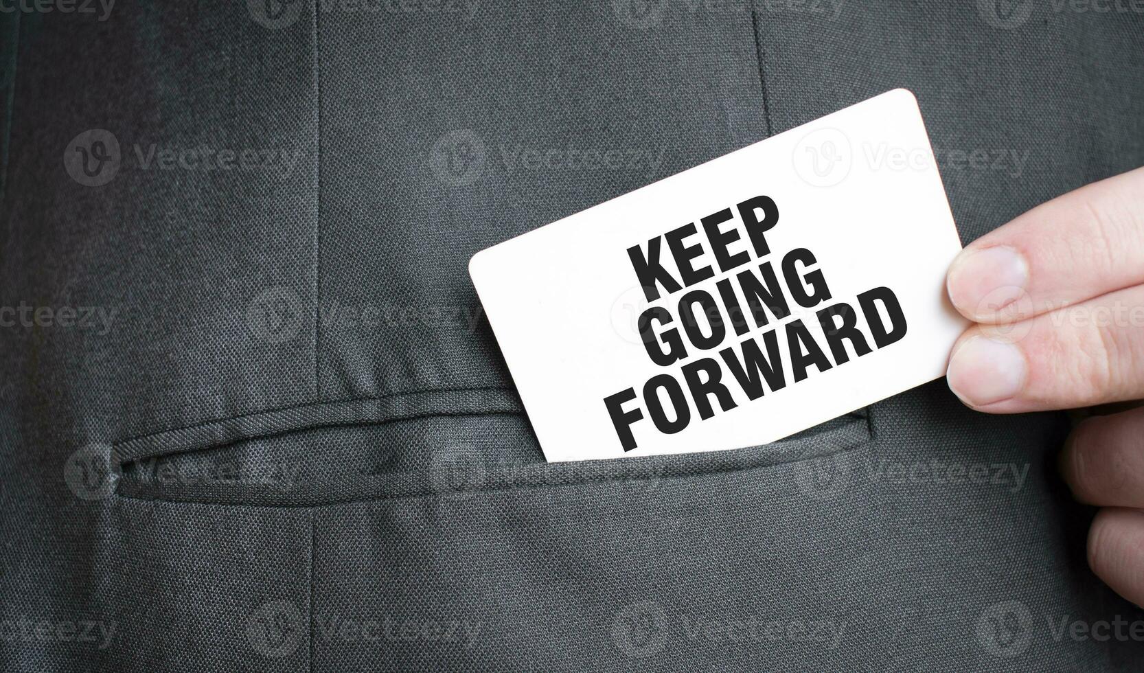 Card with KEEP GOING FORWARD text in pocket of businessman suit. Investment and decisions business concept. photo