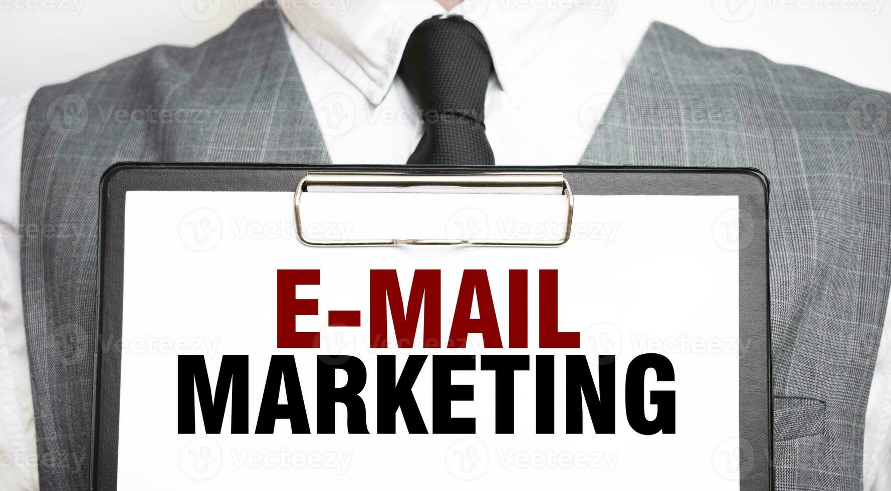 Businessman holding sheet of paper with a message e-mail marketing photo