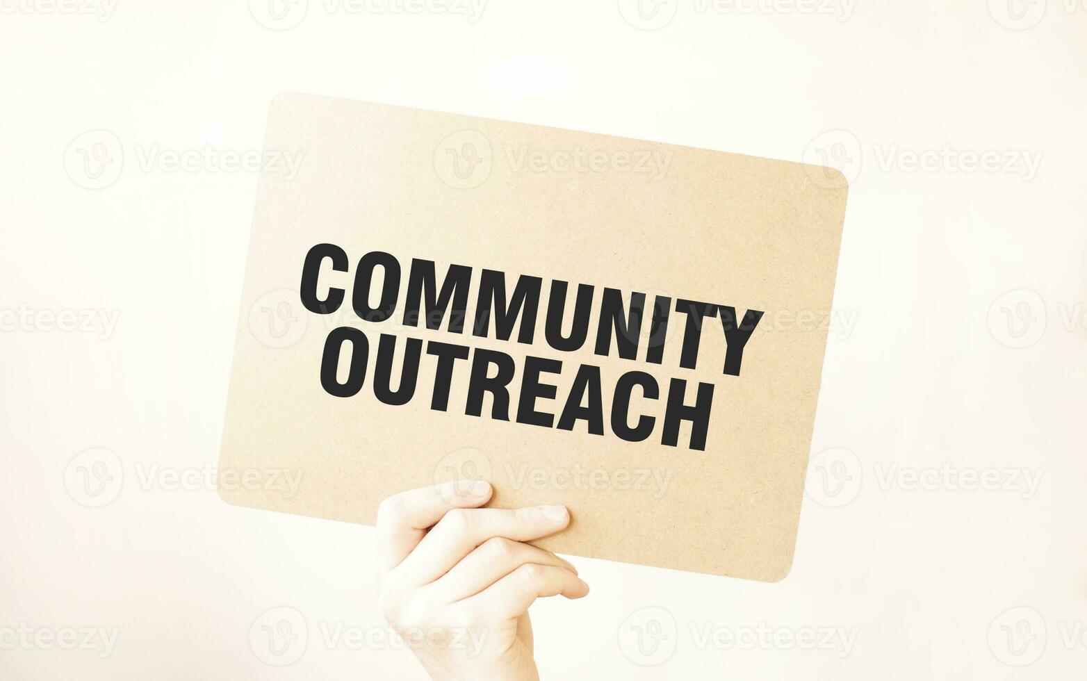 Closeup Business man hand holding show blank paper sheet mock up COMMUNITY OUTREACH photo