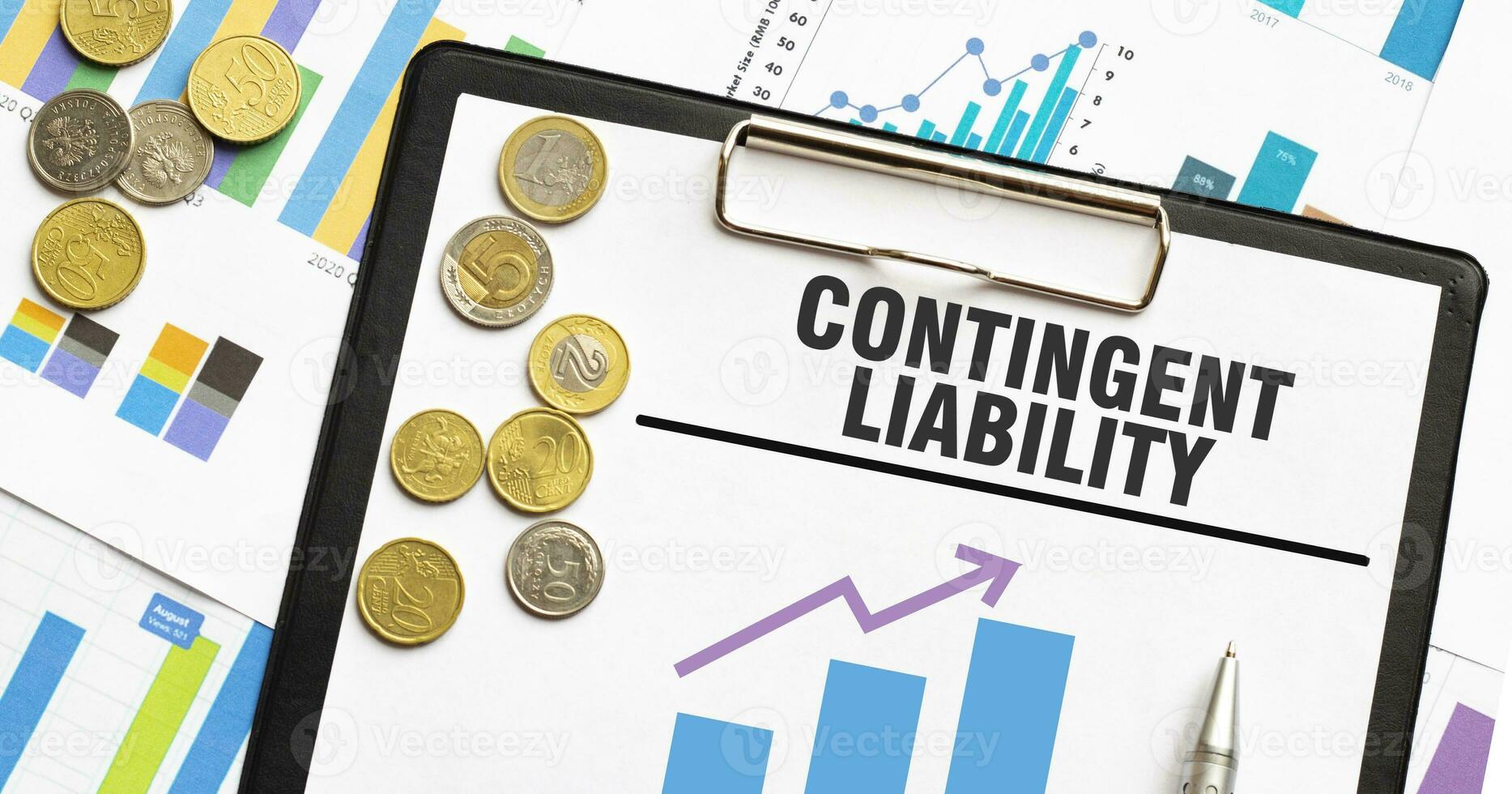 CONTINGENT LIABILITY on paper sheet with coins and charts photo