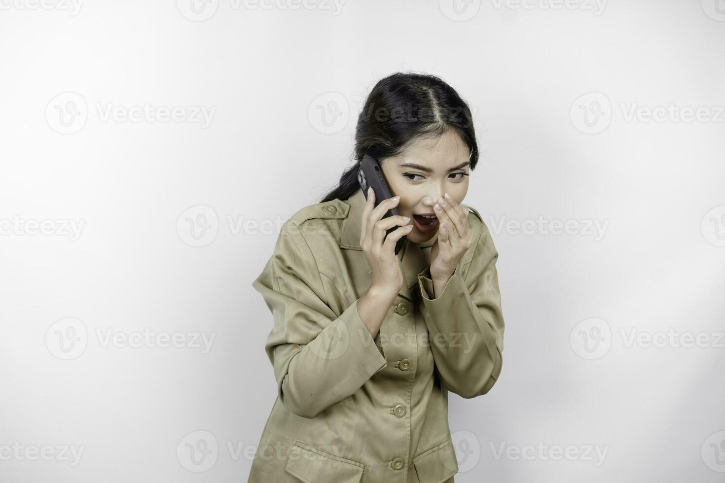 A beautiful government worker woman is talking or whispering while talking on the phone. photo