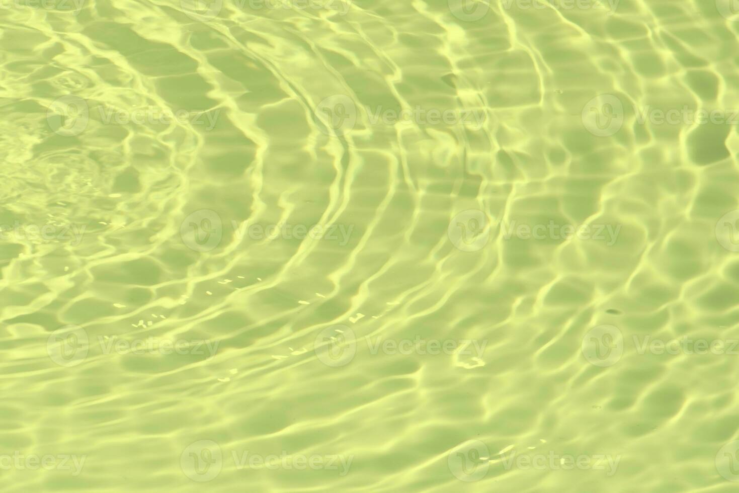 Blue water with ripples on the surface. Defocus blurred transparent blue colored clear calm water surface texture with splashes and bubbles. Water waves with shining pattern texture background. photo